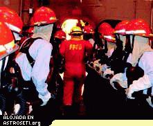 <i>Un instructor anti-fuegos encabeza bomberos para atacar un fuego Clase Bravo (alimentado por petr�leo) durante una sesi�n de entrenamiento militar. Tanto la NASA como los militares pusieron mucho �nfasis en estar preparados para varios riesgos por fuego, tanto en Tierra como en el espacio.</i> 